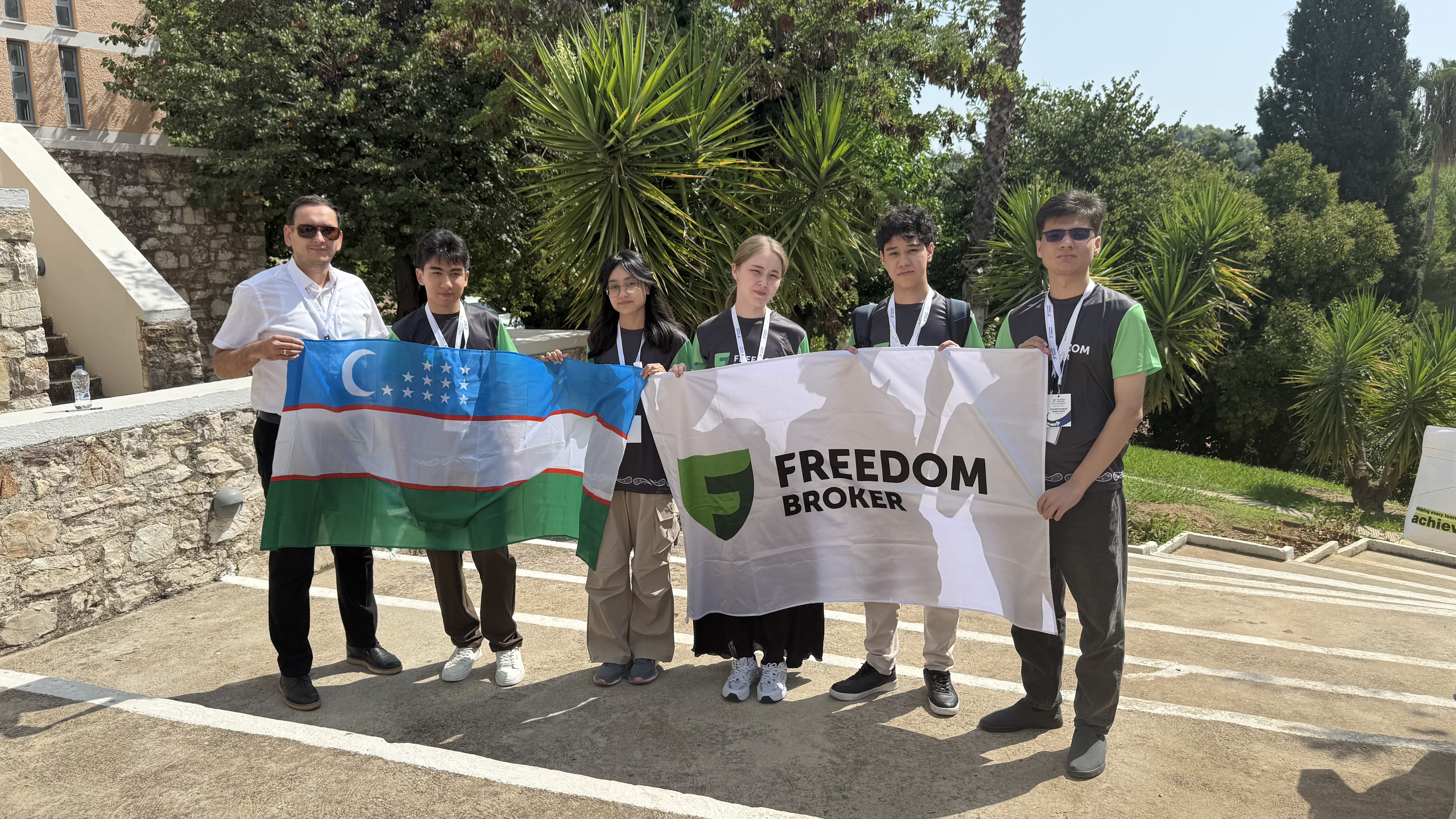 Team with Uzbekistan flag and event banner